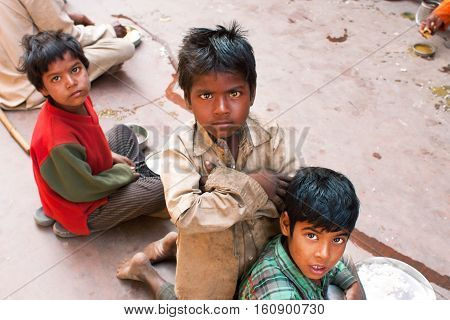 MADHYA PRADESH, INDIA - DEC 30, 2012: Unidentified poor children play on the street on December 30, 2012 in Chitrakoot India. Madhya Pradesh is the 2nd largest Indian state with 105592 primary schools