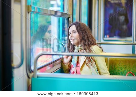 Beautiful Young Woman Travelling In A Train Of Parisian Subway