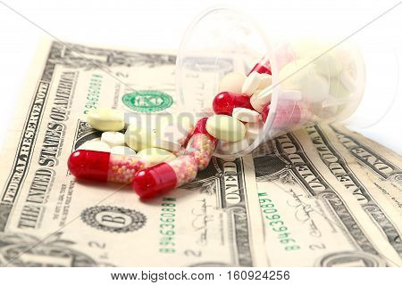 small heap of paper dollars and medical drugs