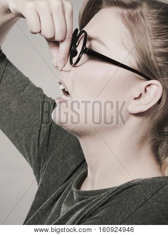 Girl Pinches Her Nose Because Of Stench Stink.