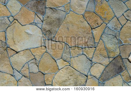 Background of a stone wall cladding texture brown stone bricks