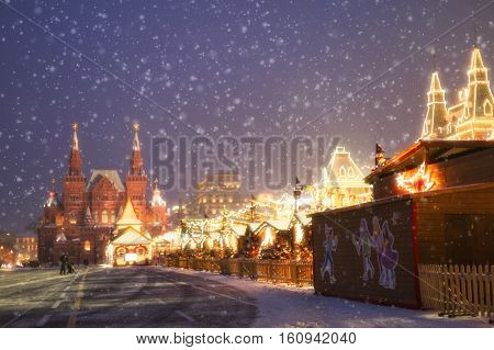 Christmas red Square in the lights during a snowfall.