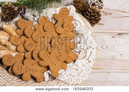 Christmas smiling gingerbread men men and women on white handmade lace with Christmas decoration