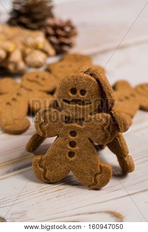 Christmas smiling gingerbread men men and women on rustic wooden background