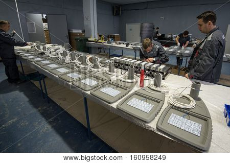 Saint-Petersburg Russia - November 30 2016: Electricians in the shop assembling urban electric lamps. for the production of lighting equipment factory.