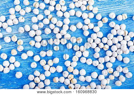 spilled many chickpeas on a blue wooden background