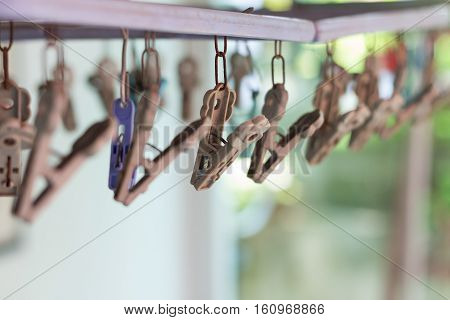 Clothes pegs or clothespins hang on a cord. Plastic clothes pegs on a washing line.(selective focus)