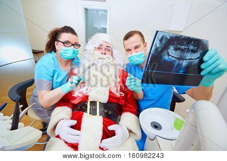 Funny concept of Santa Claus at the dentist's office on Christmas Day.