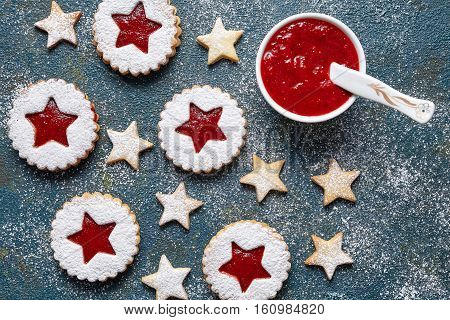 Round and star-like biscuits ginger cookies with strawberry jam. Flat lay. Traditional Austrian christmas Linzer cookie. Home Useful pastries.Top view.