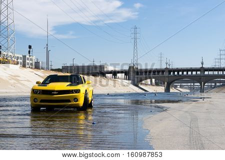 Los Angeles USA - September 28 2015: Chevrolet Camaro in Los Angeles river. Historic 6th Street viaduct bridge built in 1932 crossing the L.A. River.