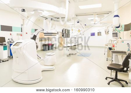 Wide view of an empty modern and state of the art operating room for cardiac and endovascular procedures
