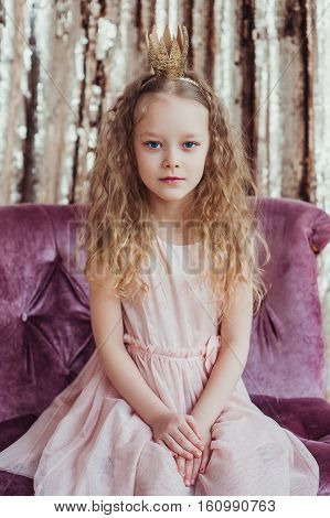 Little princess. Pretty girl with golden crown. Fashion photo.