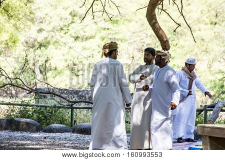 Oman Salalah - Local arab people talking during Jeep Tour at Wadi Derbat in the Sultanate green oasis 17.10.2016.