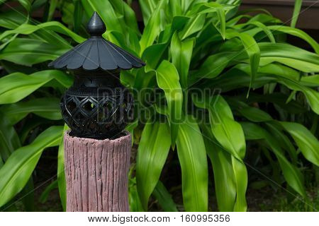Lantern on a pedestal in a garden asia