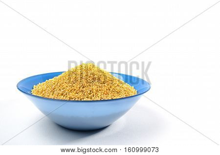 Blue bowl of barley grits isolated on white. On left side