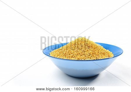 Blue bowl of barley grits isolated on white. On right side