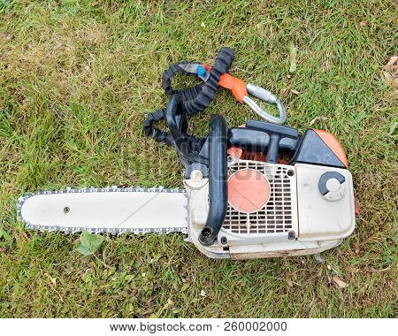 Small Chainsaw On The Ground Ready To Be Used After Being Re Fuelled
