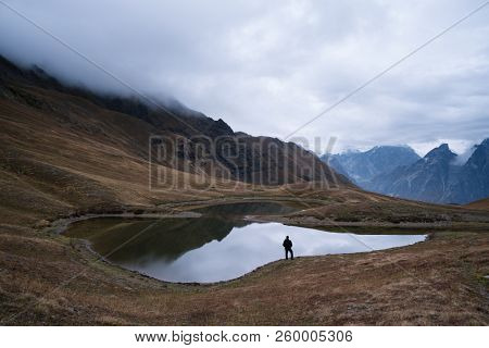 Mountain lake Koruldi. View of Main Caucasian ridge. Tourist enjoys the picturesque landscape. Samegrelo-zemo svaneti, Georgia