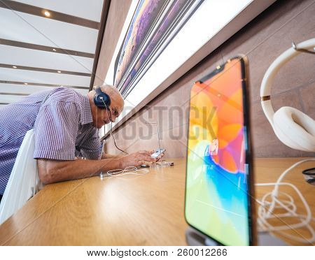 Strasbourg, France - Sep 21, 2018: Funny Curious Caucasian Senior Man Testing Apple Beats By Dr Dre 