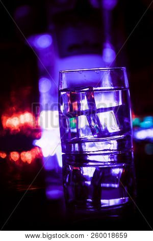 Colored Lighting Of Glasses In The Night Club Bar