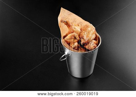 Bbq Chicken Wings In A Metal Bucket Onblack Background With Sauce Menu