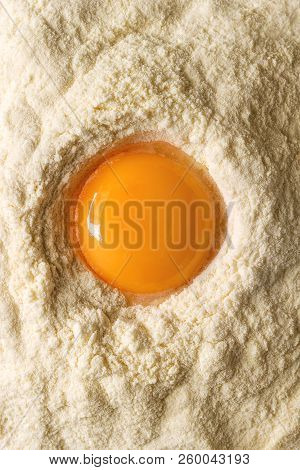 Ingredients For Homemade Italian Pasta. Egg Yolk In Semolina Flour. Flat Lay, Close Up. Cooking Konc
