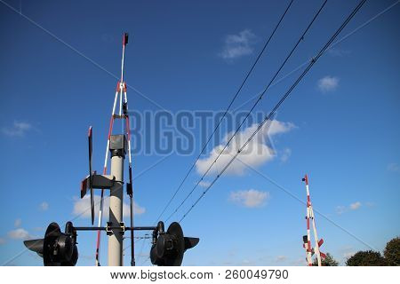 Railroad Crossing With Barriers, Red Lights And Bells At The Single Track At Nieuwerbrug In The Neth