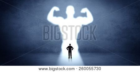 Businessman standing and dreaming about a strong superhero