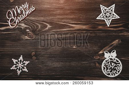 View From Above Of A Merry Christmas Inscription And Handmade Tree Toys On Wooden Background, Greeti