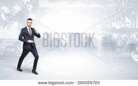 Young suited karate trainer doing karate tricks on the top of a metropolitan city