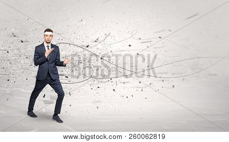 Young suited karate trainer doing karate tricks with chaotic concept