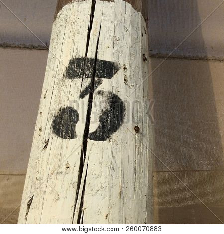 Number Three, Black Figure Three On A White Background, Number On A Pole, Dense Mesh As A Background