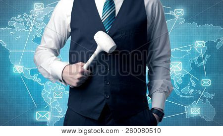Businessman holding tool with global map graphic on the background