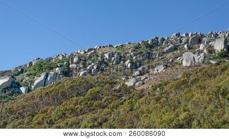 Stony Flank Of Hill Against The Background Of The Sky