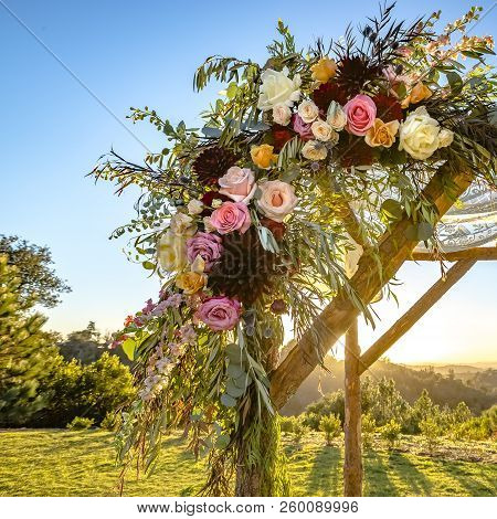 Colorful Flowers And Lace Cloth On A Wooden Huppah