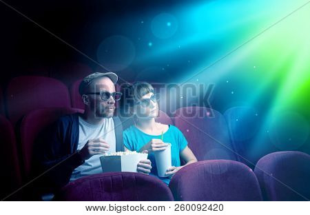 Teenager couple cuddling and watching the climax part of the movie