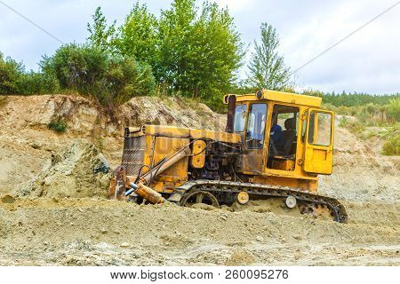 Bulldozer Operation In Quarry With Sand . Daylighting Rain Clouds