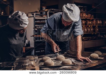 Cooking Master Class In Bakery. Chef With His Assistant Showing Ready Samples Of Baking Test In Kitc