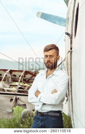 The Man In The Shirt Stands At The Old Plane