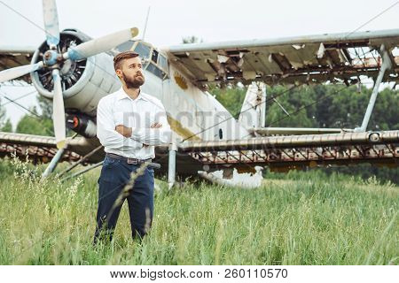 The Man In The Shirt Stands At The Old Plane