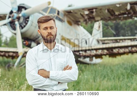 The Man In The Shirt Stands At The Old Plane