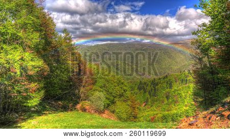 Landscape Of Mavrovo National Park With Rainbow, Mountain And Lake In Fyr Macedonia