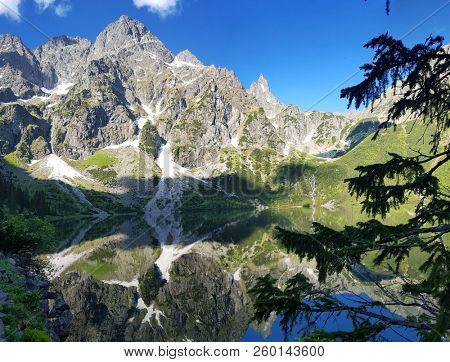 Morskie Oko. High Tatras, Poland, May 27, 2018. Beautiful landscape of snowy mountain tops and the lake between them. View from the mountain Rysy.