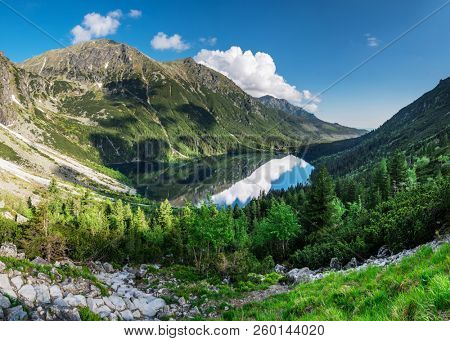 Landscape of High Tatras in the spring. Snowy mountain tops and beautiful sky. Mountain Rysy, Morskie Oko.