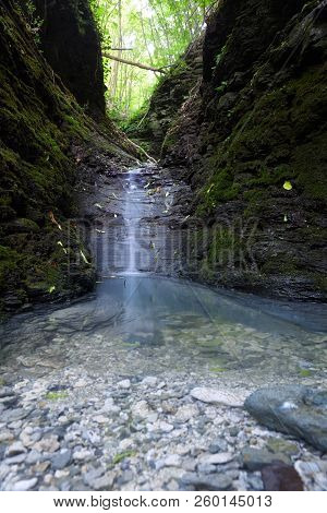 Cascade Falls Over Mossy Rocks. Spring In Forest.magic Lightnings.deep Forest Athmosphere.