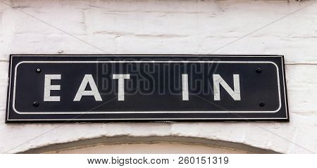 Vintage Eat In Sign In White Painted Brick Wall Of Restaurant In Stratford-upon-avon In Warwickshire
