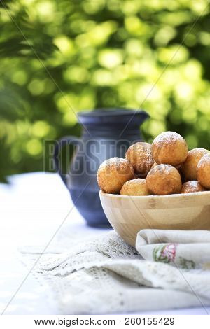 Small Balls Of Freshly Baked Homemade Cottage Cheese Doughnuts In A Plate . Donuts In Powdered Sugar