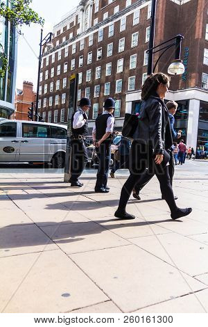 London, Uk - June 9, 2015: Oxford Street. Two Unrecognizable Police Officers In Traditional Uniform 