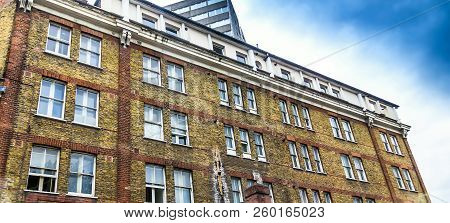 Old Historic Brick Building In English Style On City Road With Apartments And Flats For Rent Or Sale