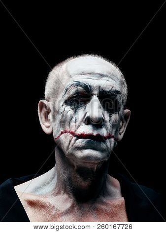 Bloody Halloween Theme: The Crazy Maniak Face On Dark Studio Background